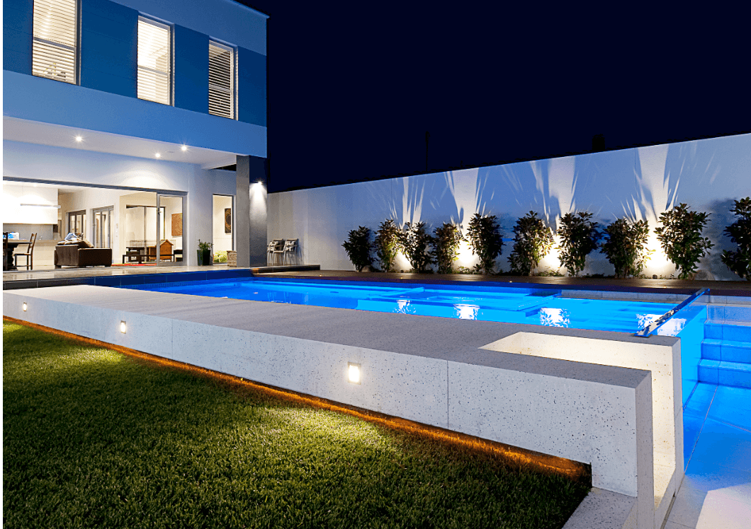 Swimming pool illuminated with colourful underwater lights
